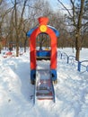 Red children's slide as a locomotive in the snow park area of Ã¢â¬â¹Ã¢â¬â¹the city Royalty Free Stock Photo